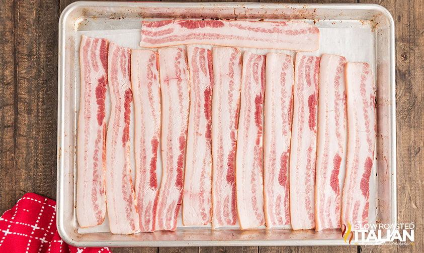 sliced bacon on a baking sheet