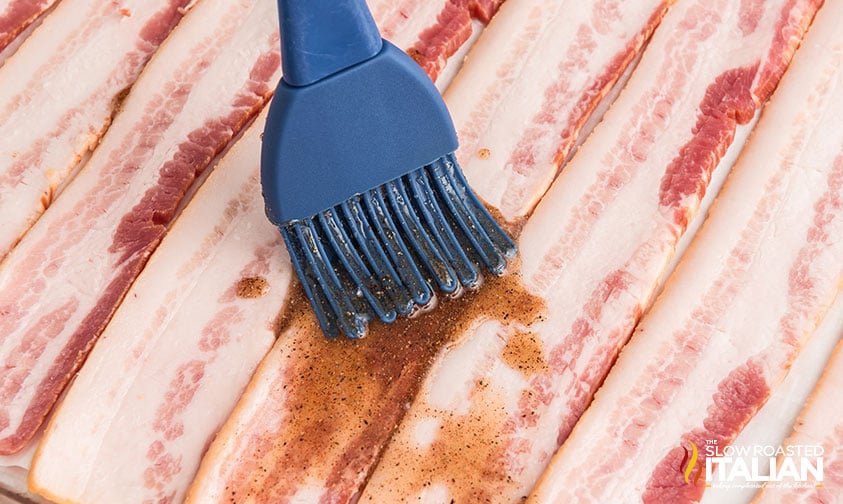 brushing maple syrup mixture on sliced bacon