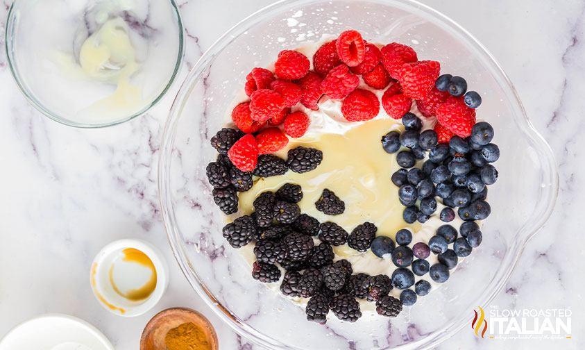 adding fresh berries to whipped ice cream mixture