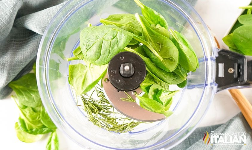 overhead: spinach and rosemary leaves in a food processor