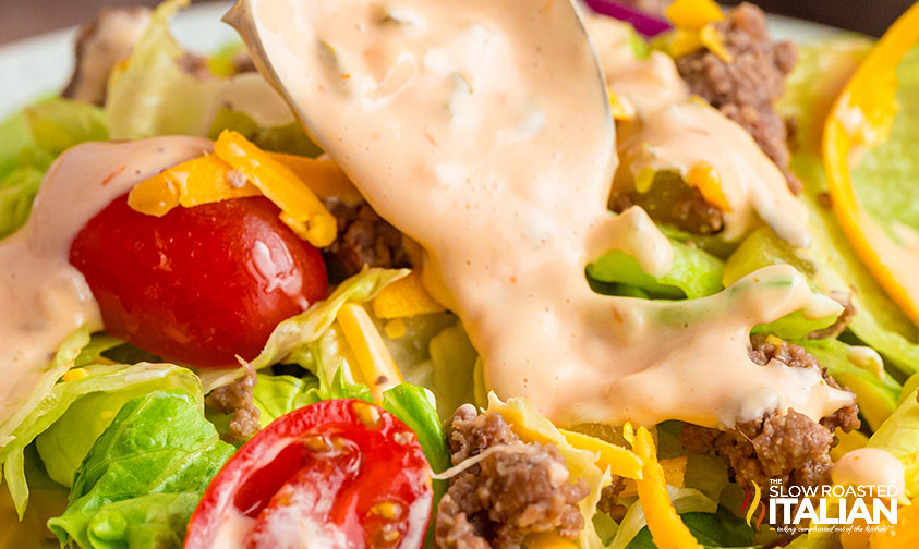 closeup of big mac sauce drizzled on salad