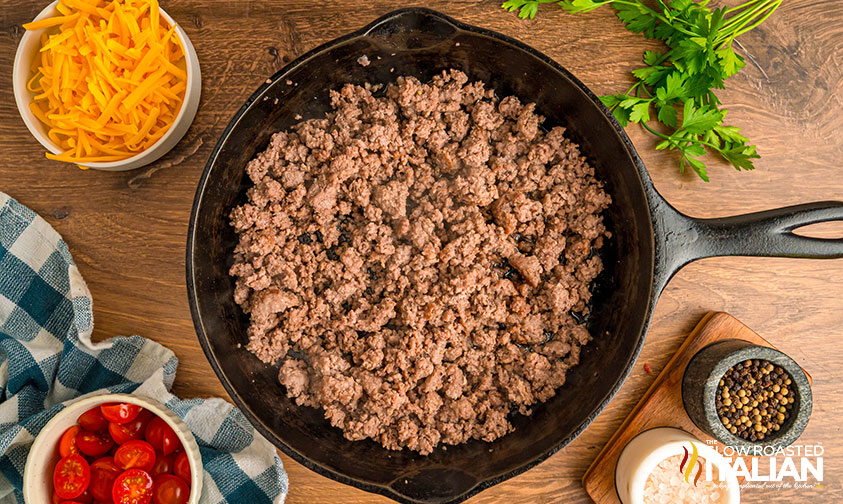 browned ground beef in a cast iron skillet