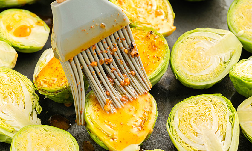 brushing brussel sprouts with garlic butter