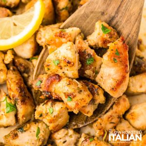 garlic butter chicken bites on a wooden spoon