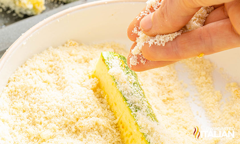 tossing zucchini in almond flour breading