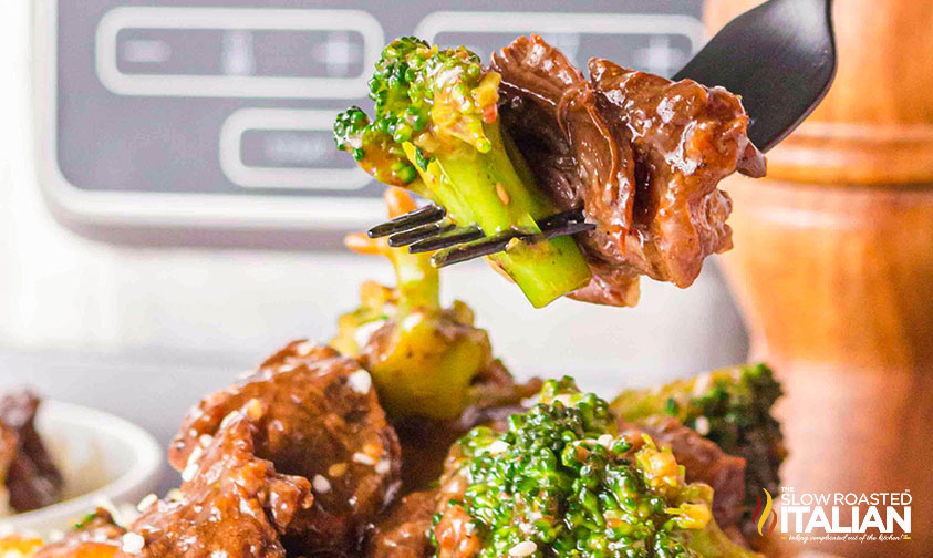 closeup of slow cooker broccoli and beef on a fork