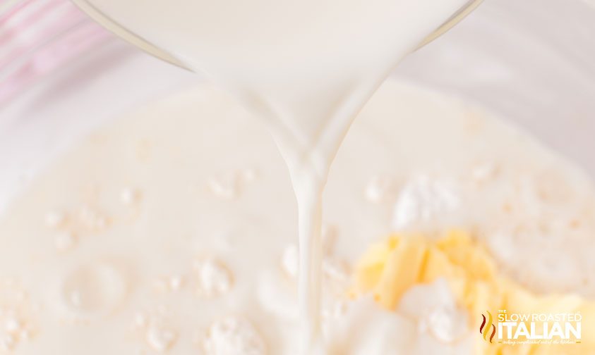 pouring milk into bowl of no yeast bread ingredients