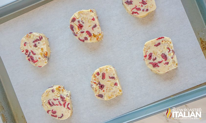 sliced cranberry pecan shortbread on parchment lined baked sheet