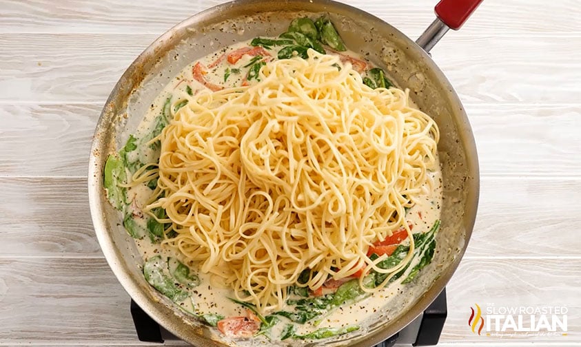 cooked linguine in skillet of creamy spinach bell pepper sauce