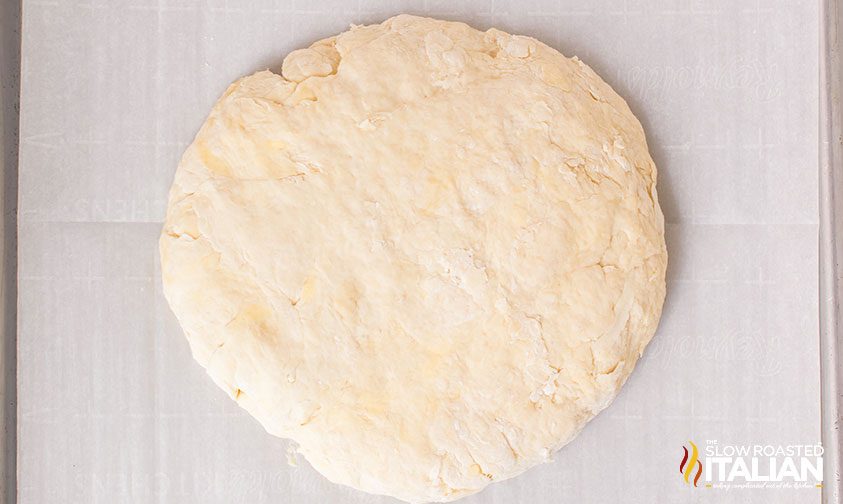 kneaded dough round on parchment lined pan