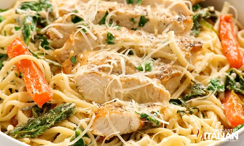 close up: chicken, bell peppers, and spinach with noodles in creamy sauce