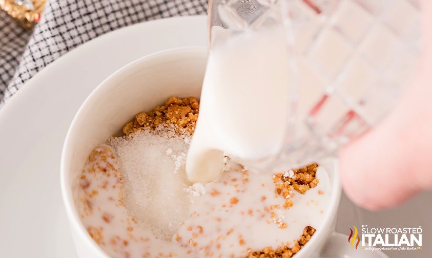 pouring milk into mug with crushed Nutter Butters