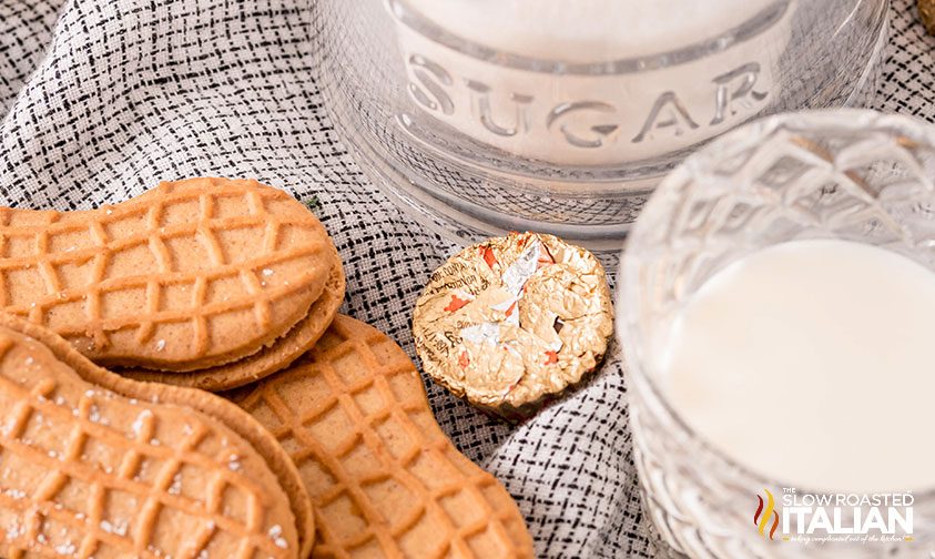 Nutter Butter cookies, sugar, milk, and a Reese's cup on a towel