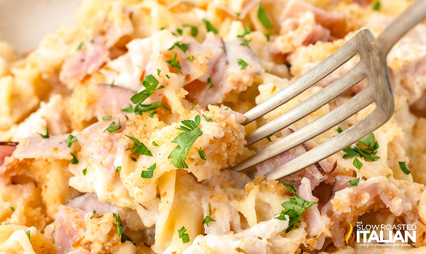 closeup of a fork digging into chicken cordon bleu