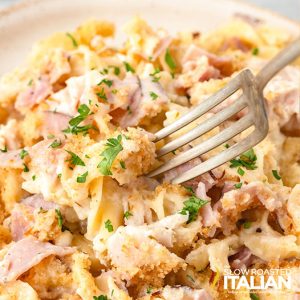 fork digging into chicken cordon bleu casserole