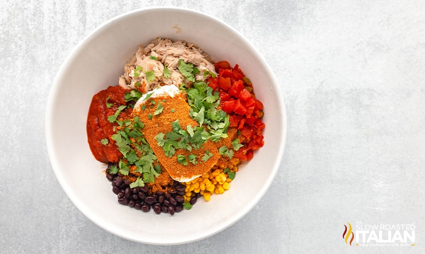 ingredients for chicken taco casserole in a large mixing bowl