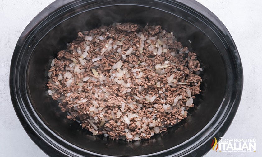 adding ground beef mixture to crockpot