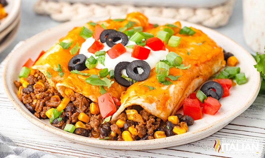 cheesy beef enchiladas on a plate