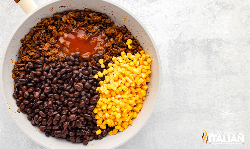 ground beef sauce, beans and corn in a skillet