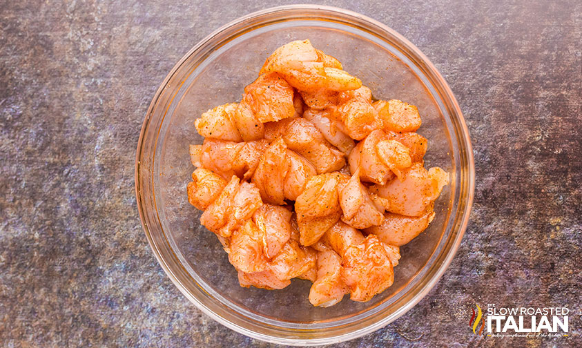 pieces of chicken seasoned in a small bowl