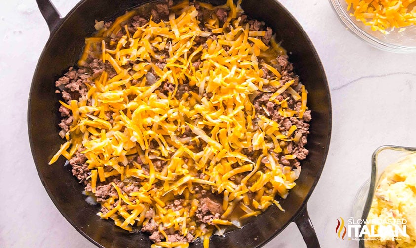 adding cheese to ground beef mixture