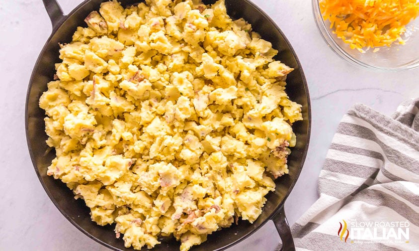 adding mashed potatoes to ground beef mixture