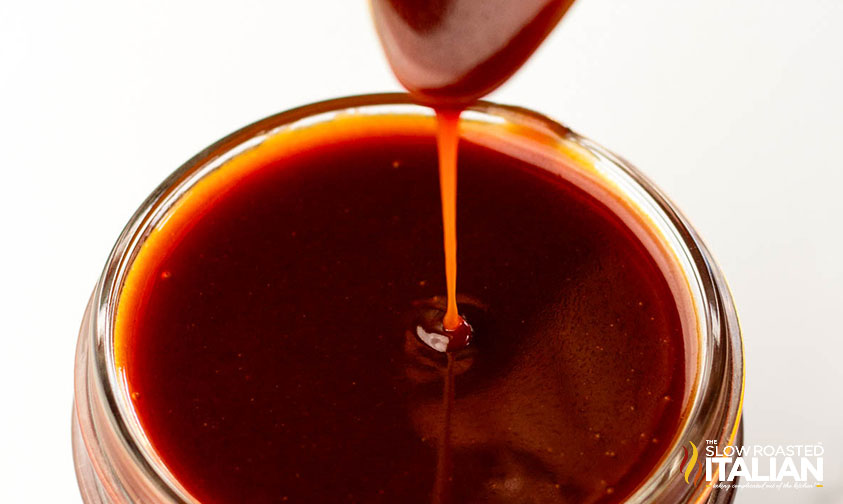 pouring salted caramel sauce in a glass jar