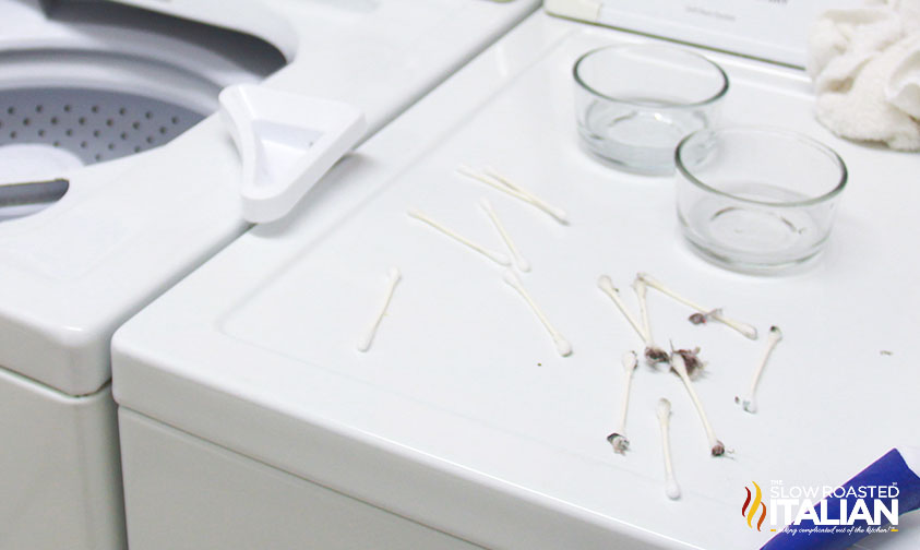 cleaning washing machine crevices with cotton swabs