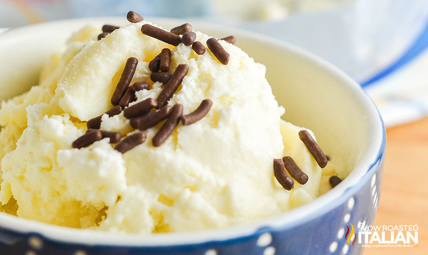 bowl of homemade ice cream in a bag scooped into a bowl with chocolate sprinkles on top