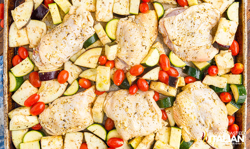 Italian sheet pan chicken thighs recipe on a baking sheet