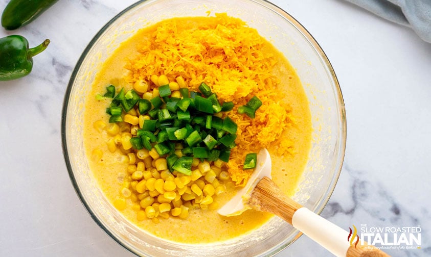 folding shredded cheese, jalapeno and corn into cornbread mixture