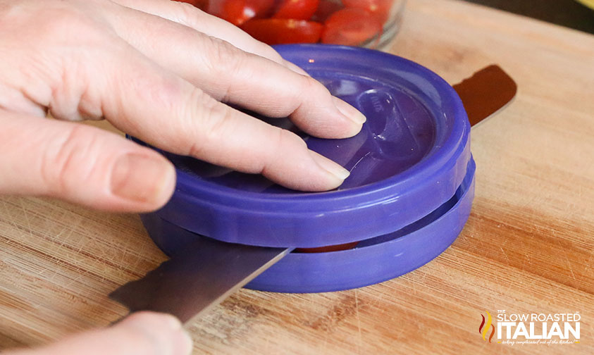 slicing through cherry tomatoes