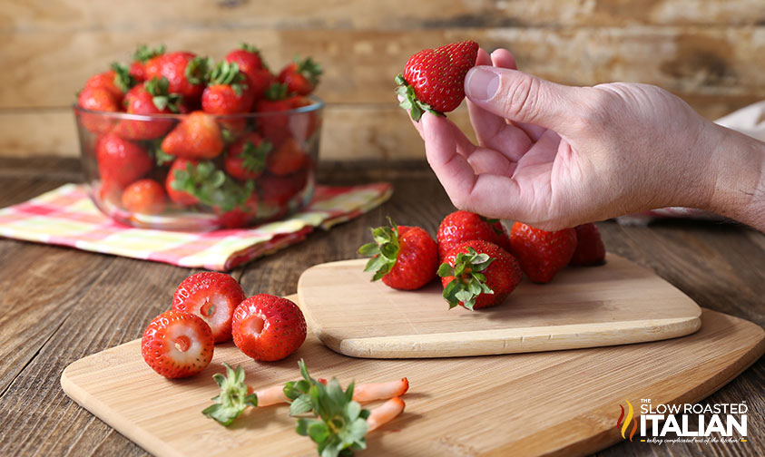 hand holding a fresh strawberry