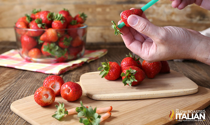 green straw inserted into strawberry