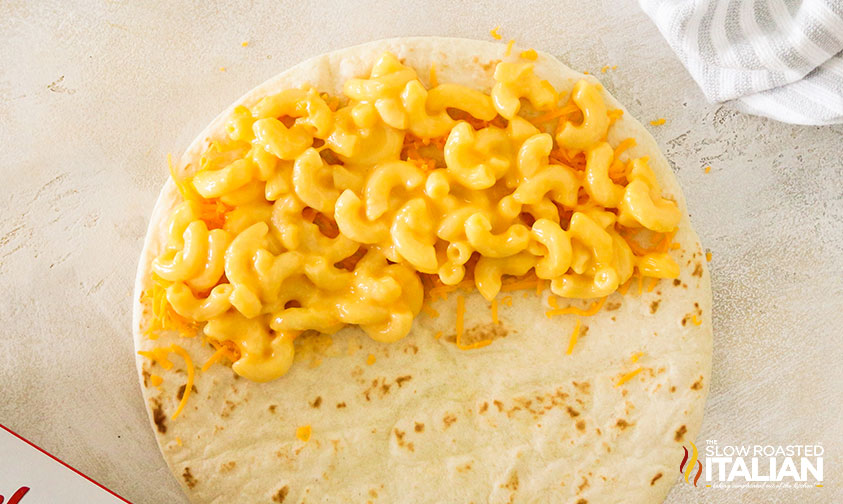 adding mac and cheese to a tortilla