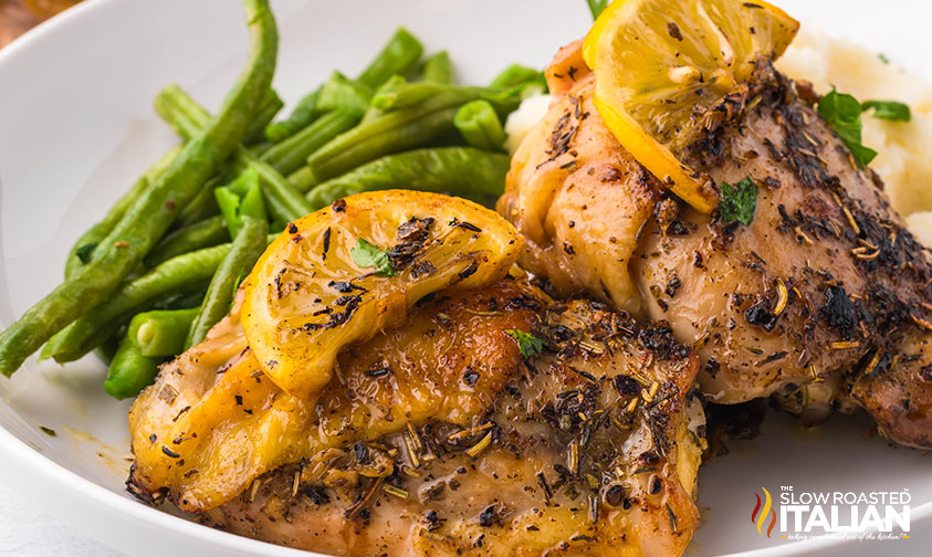 pan seared chicken thighs with green beans and mashed potatoes on a plate