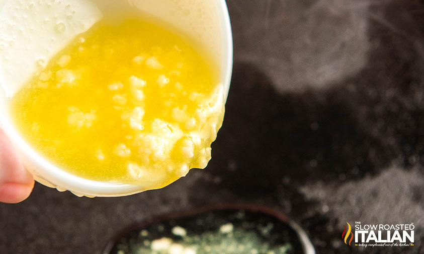 adding butter garlic and rosemary to skillet