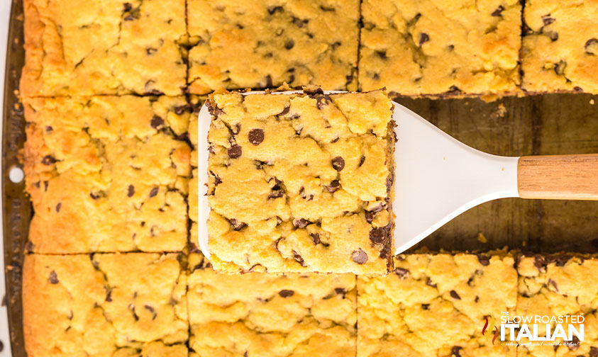 sheet pan chocolate chip cookie on a spatula