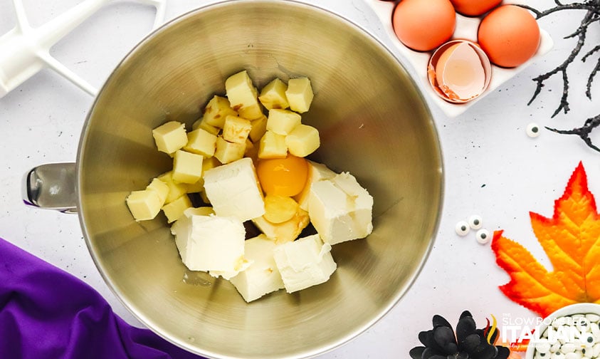 butter, cream cheese and eggs in a mixing bowl