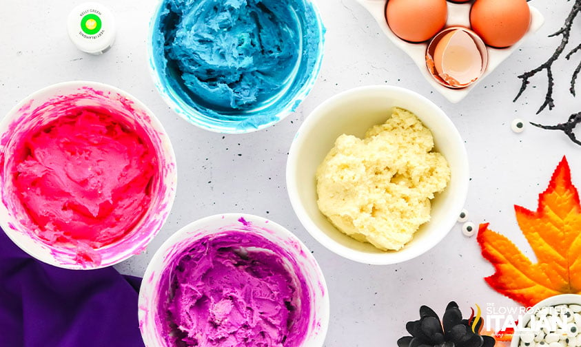 different colored cookie dough in small bowls