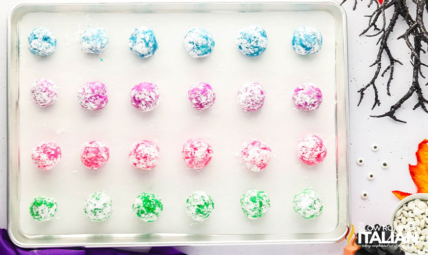 cookie dough rolled into balls on a baking sheet