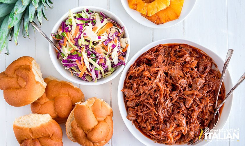 bowls of pulled pork, coleslaw, and grilled pineapple rings with challah buns