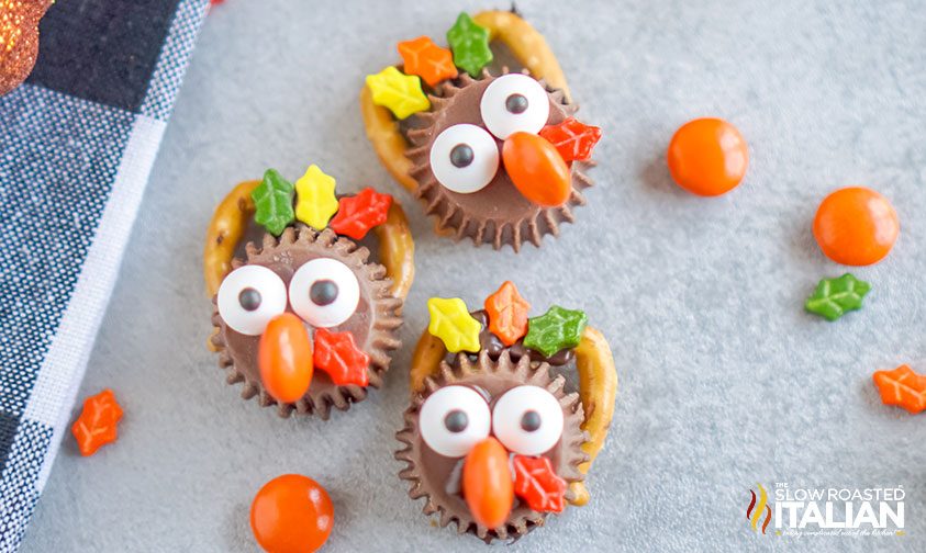 pretzel turkeys with leaf sprinkle feathers on parchment paper