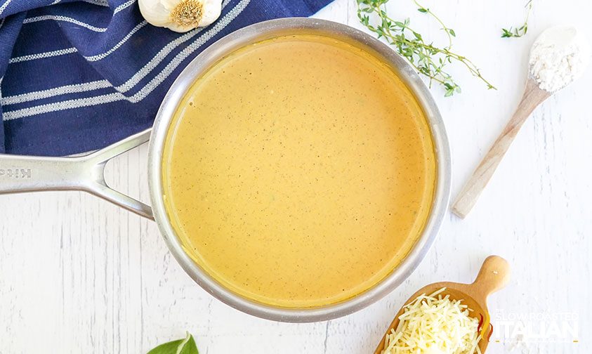 pumpkin sauce in saucepan surrounded by ingredients