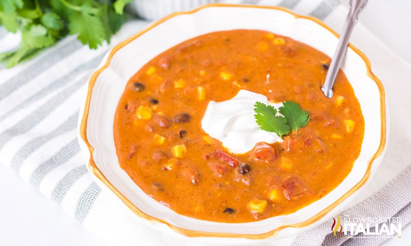 bowl of taco soup topped with sour cream and parsley