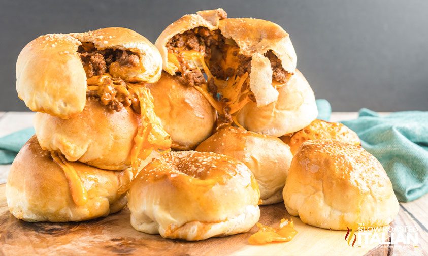 pile of pretzel bites stuffed with sloppy joe filling and cheese, some split open