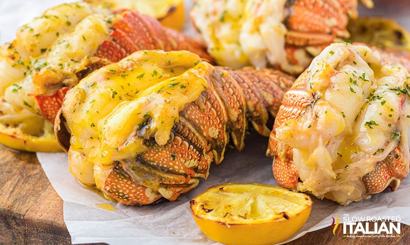 air fryer lobster tails on a wood board