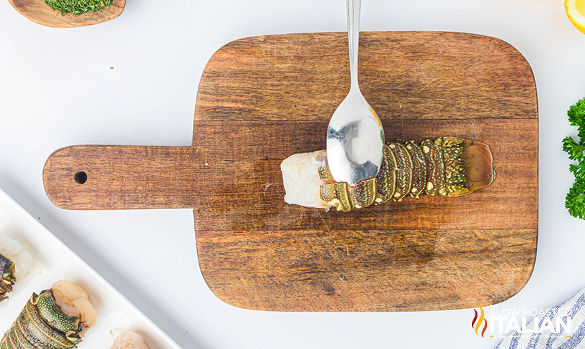 peeling shell from lobster tail