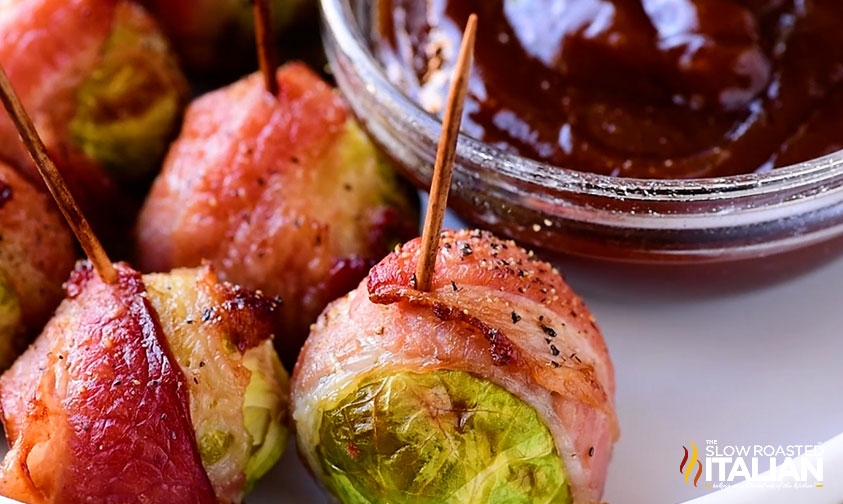 plate of bacon wrapped brussel sprouts with dipping sauce