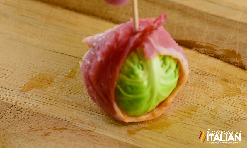 using a tooth pic to keep bacon wrapped around brussel sprouts